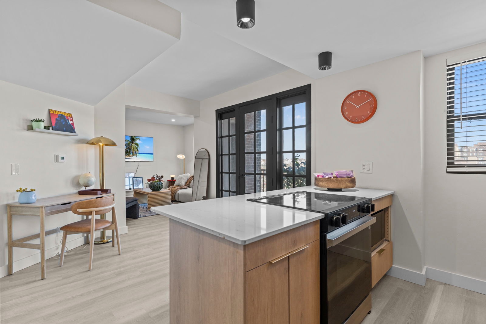 One bedroom luxury apartment at The Harper, Central West End St. Louis — open kitchen with quartz island and French doors, starting at $1,499/mo