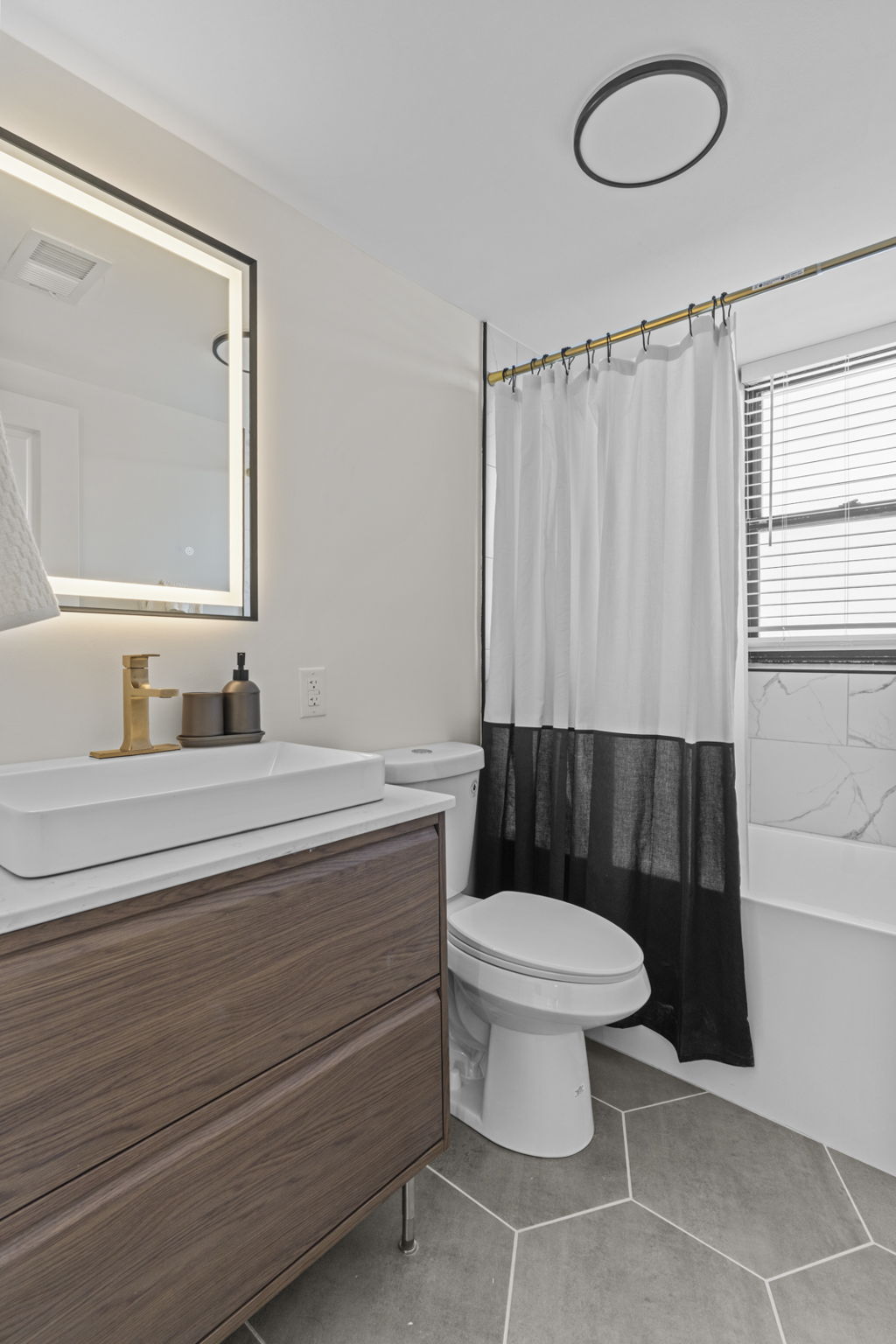 Harper bathroom with lighted mirror and deep vanity storage